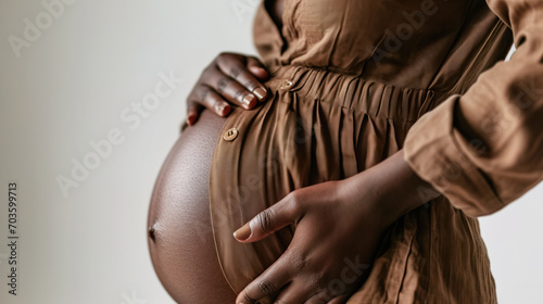 Close up of Afro American woman pregnant belly. Unrecognizable person, copy space for text photo