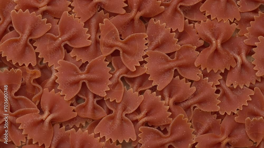 Italian red farfalle pasta background. Table spin. Italian red farfalle pasta background. Table spin.