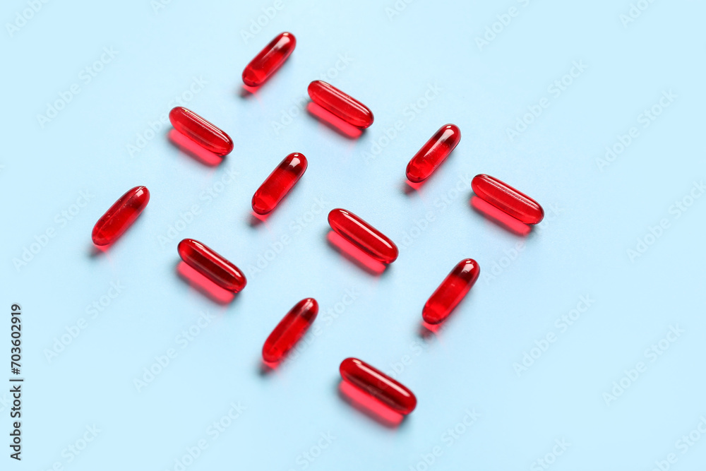 Composition with red capsules on color background Composition with red capsules on color background