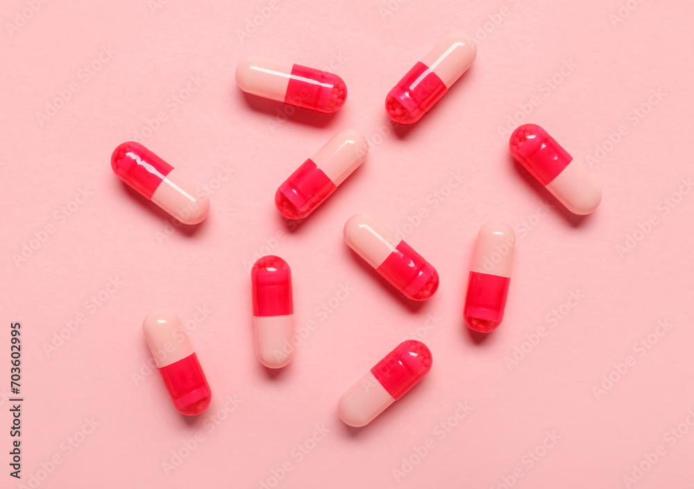 Medical capsules on pink background Medical capsules on pink background