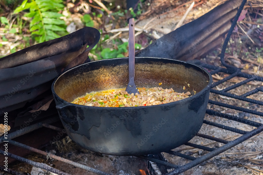 Preparation of pilaf in a cauldron on the fire Preparation of pilaf in a cauldron on the fire