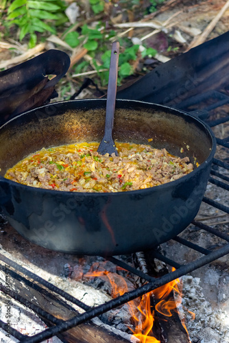 Preparation of pilaf in a cauldron on the fire
