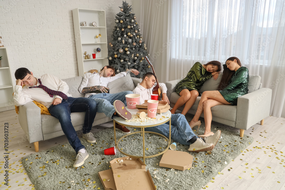 Group of drunk young people sleeping after New Year party at home Group of drunk young people sleeping after New Year party at home