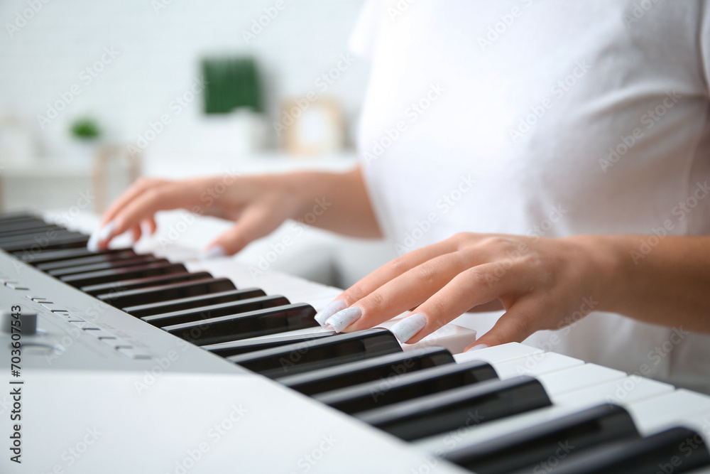 Young woman playing synthesizer at home, closeup Young woman playing synthesizer at home, closeup