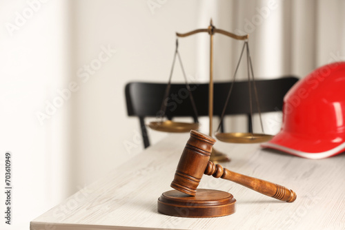 Law concept. Gavel, scales and red hard hat on white wooden table, space for text