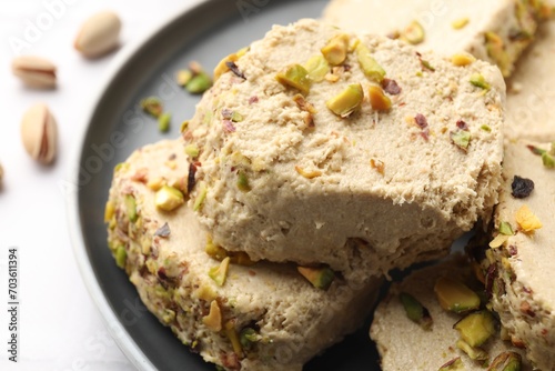 Tasty pistachio halva on white table  closeup