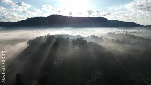 Aerial view  of flowing fog waves on mountain tropical rainforest.Khao Kho, Phetchabun, Thailand. photo