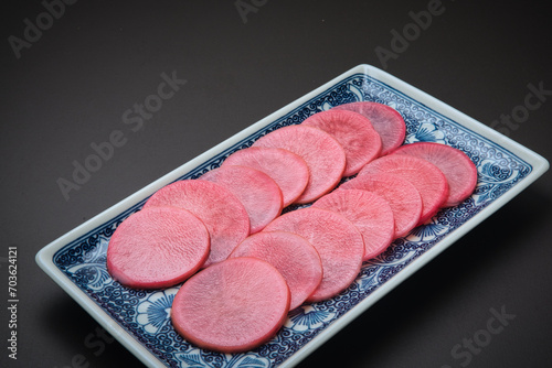 Purple radish sliced into rounds and dipped in sweet vinegar, with a beautiful coloring. photo