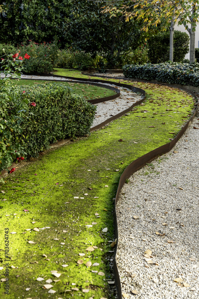 A moss path lined with metal sides