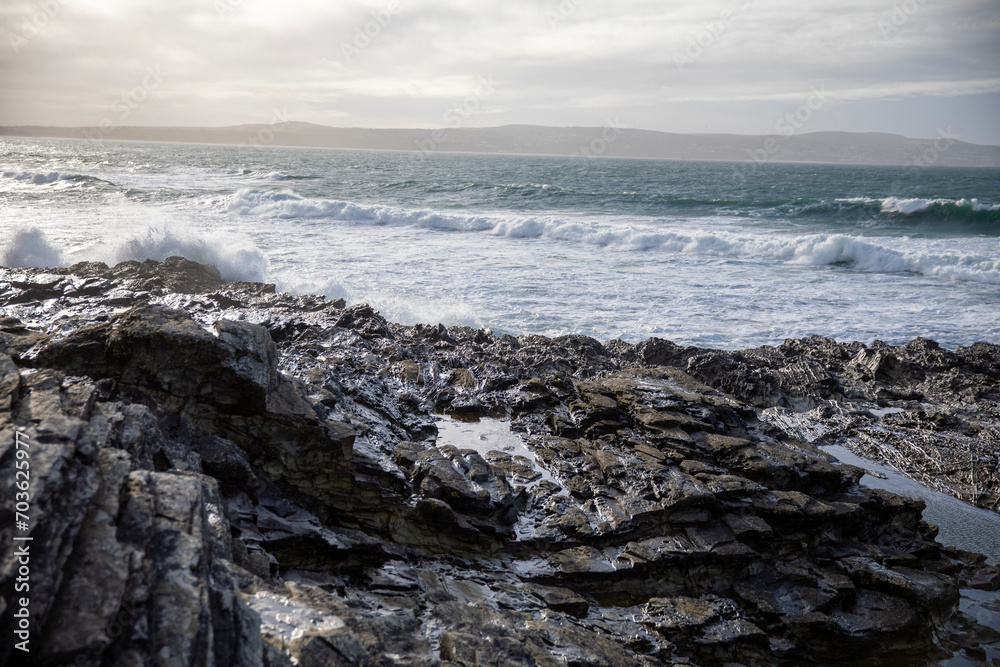 Waves crashing on the rocky shore at Godrevy Beach in the UK. Waves crashing on the rocky shore at Godrevy Beach in the UK.