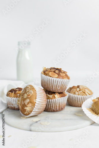 almond muffins on a white marble tray, homemade bakery style almond muffins on a white background