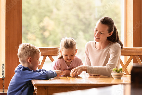 Happy mother and children relaxing at home playing creative toy game together  fatherhood family parenting concept 