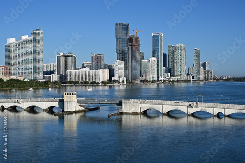 Residential waterfront buildings and Venetian Causeway on Biscayne Bay in Miami, Florida on clear calm sunny December morning..