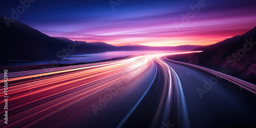 The glowing trails of cars on an early dawn road © Putra