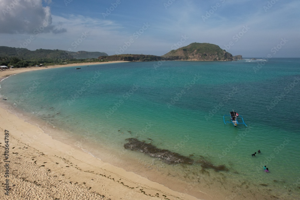Aerial view of Tanjung Aan beach in Lombok island, West Nusa Tenggara, Indonesia. white sandy beach with turquoise water. tropical beach view. This beach is famous for its waves for surfing. Aerial view of Tanjung Aan beach in Lombok island, West Nusa Tenggara, Indonesia. white sandy beach with turquoise water. tropical beach view. This beach is famous for its waves for surfing.