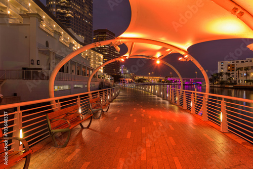 Riverwalk at Night - A wide-angle night view of colorfully illuminated Tampa Riverwalk, winding along side of Hillsborough River, at Downtown Tampa, Florida, USA. photo