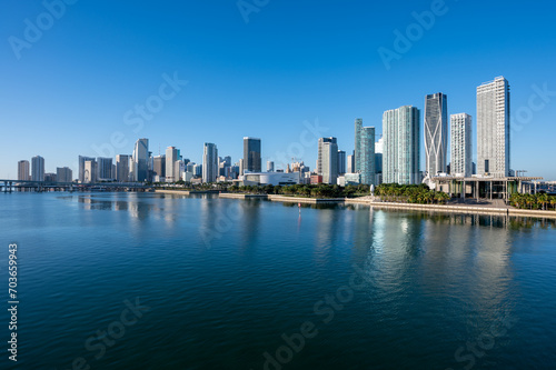 City of Miami, Florida reflected in calm water of Biscayne Bay on sunny December morning.