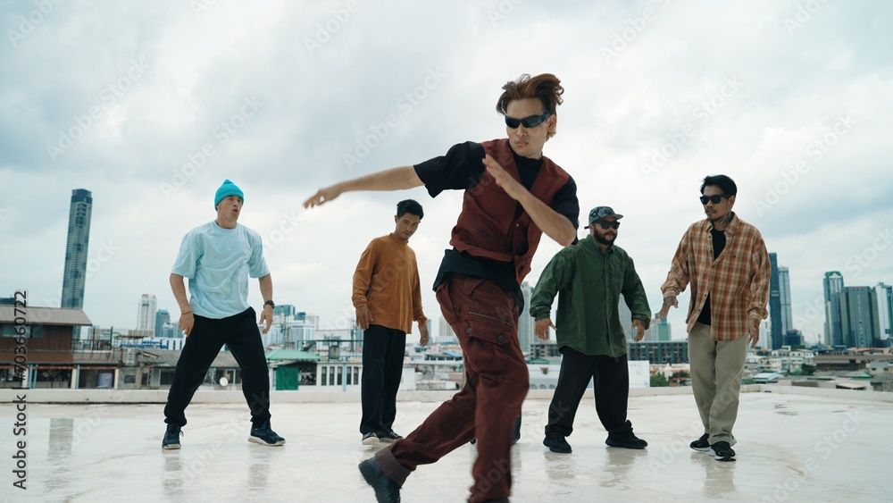 Professional break dance team practice B-boy dance while multicultural friends at rooftop. Young modern dancing group doing hip hop movement. Style,fashion,action. Outdoor sport 2024. Endeavor. - obrazy, fototapety, plakaty 
