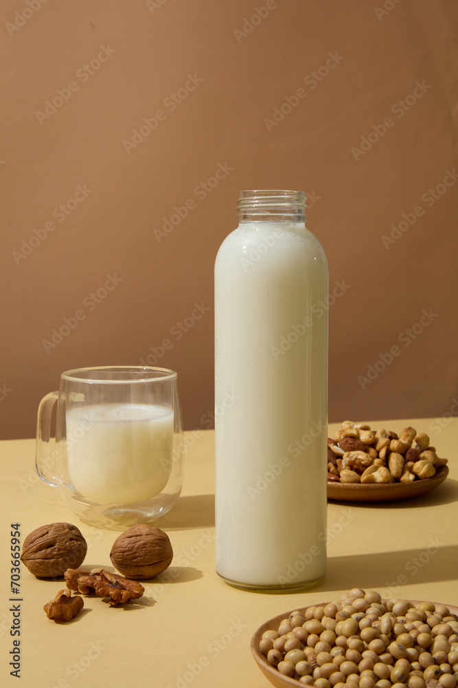 Wooden dishes of soybeans, cashew nuts and walnuts displayed on beige surface with containers of milk. Nuts are a great source of several nutrients, including vitamin E Wooden dishes of soybeans, cashew nuts and walnuts displayed on beige surface with containers of milk. Nuts are a great source of several nutrients, including vitamin E