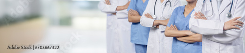 Confident medical staff team with doctor nurse and healthcare specialist professions people in blurry hospital corridor background. Medical and healthcare community in panoramic banner. Neoteric © Summit Art Creations