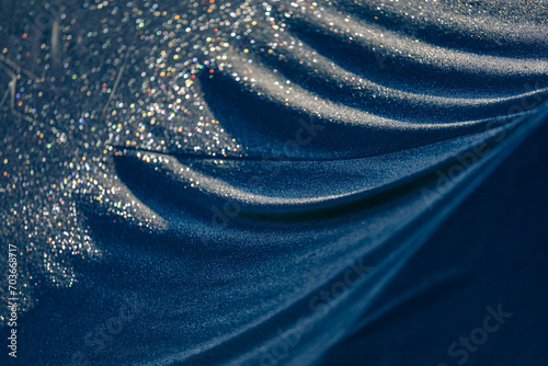 Drops of water on a dark matte surface close up.