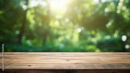 empty wood table top on blurred abstract green from garden with sunlight