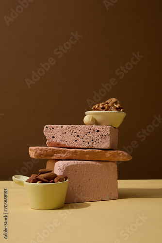 A stack of several stones with a small bowl containing nuts placed on top. Soy extract has anti-inflammatory properties, which can help to calm irritated or inflamed skin