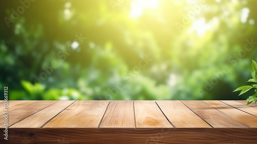 beautiful empty wood table top on blurred abstract green from garden with sunlight