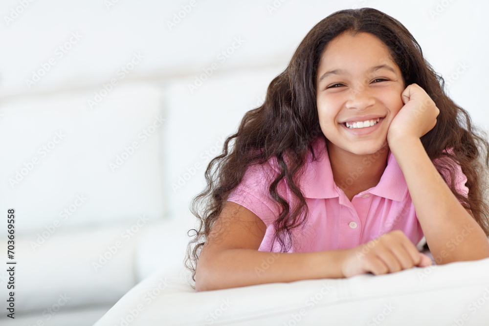 Smile, sweet and portrait of girl child at her home with positive, good and confident attitude. Happy, cute and face of young kid from Colombia sitting and relaxing in living room at modern house. Smile, sweet and portrait of girl child at her home with positive, good and confident attitude. Happy, cute and face of young kid from Colombia sitting and relaxing in living room at modern house.