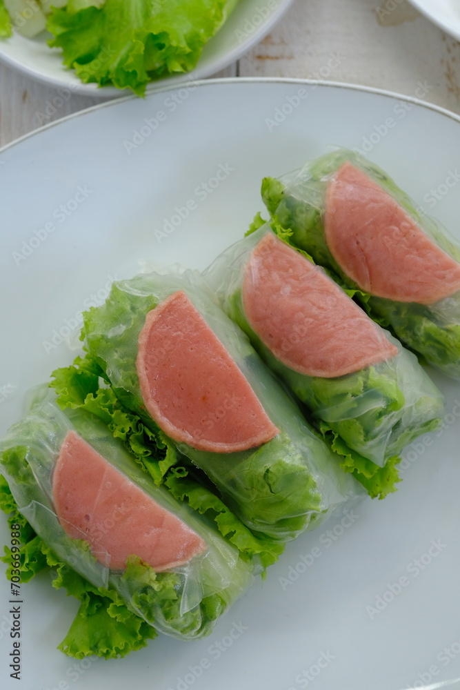 Spring rolls are a rolled appetizer or dim sum commonly found in Chinese and Asian cuisine. Raw fresh vegetable salad roll with mayonnaise. Spring rolls are a rolled appetizer or dim sum commonly found in Chinese and Asian cuisine. Raw fresh vegetable salad roll with mayonnaise.