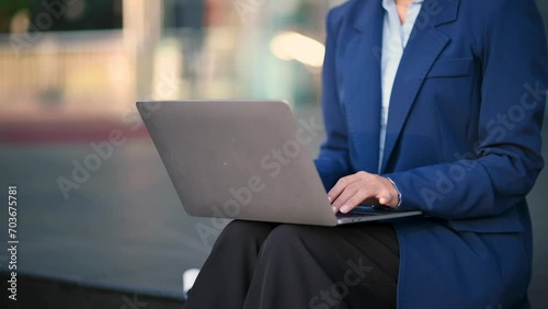 Young Asian business woman leader entrepreneur, professional manager holding digital tablet computer uon the street in big city photo