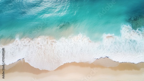 Aerial view of a white sandy beach meeting turquoise ocean waters