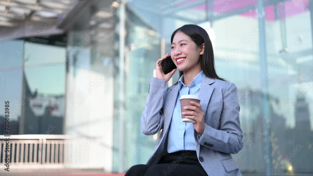 Young Asian business woman leader entrepreneur, professional manager holding digital tablet computer uon the street in big city Young Asian business woman leader entrepreneur, professional manager holding digital tablet computer uon the street in big city