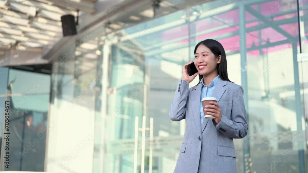 Young Asian business woman leader entrepreneur, professional manager holding digital tablet computer uon the street in big city Young Asian business woman leader entrepreneur, professional manager holding digital tablet computer uon the street in big city