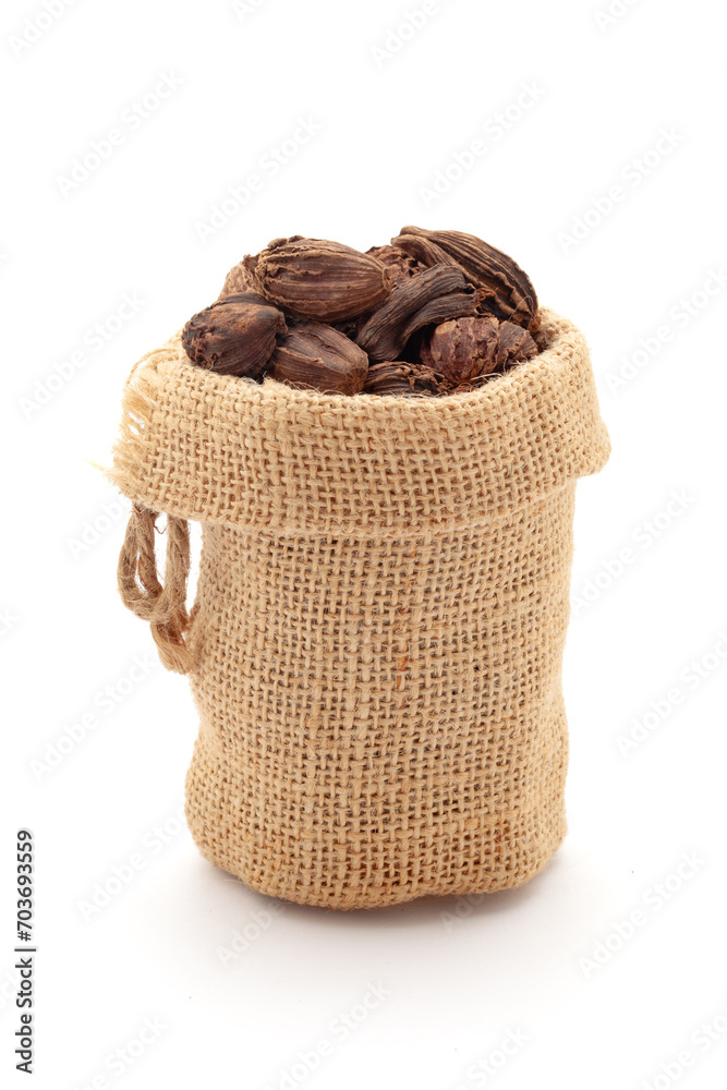 Close-up of Organic Black Cardamom (Amomum subulatum), in a jute bag. Isolated over a white background. Close-up of Organic Black Cardamom (Amomum subulatum), in a jute bag. Isolated over a white background.