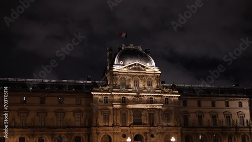 Louvre by night. 4K video with this landmark modern architecture building from Paris during the evening view to the pyramid and facade details. photo