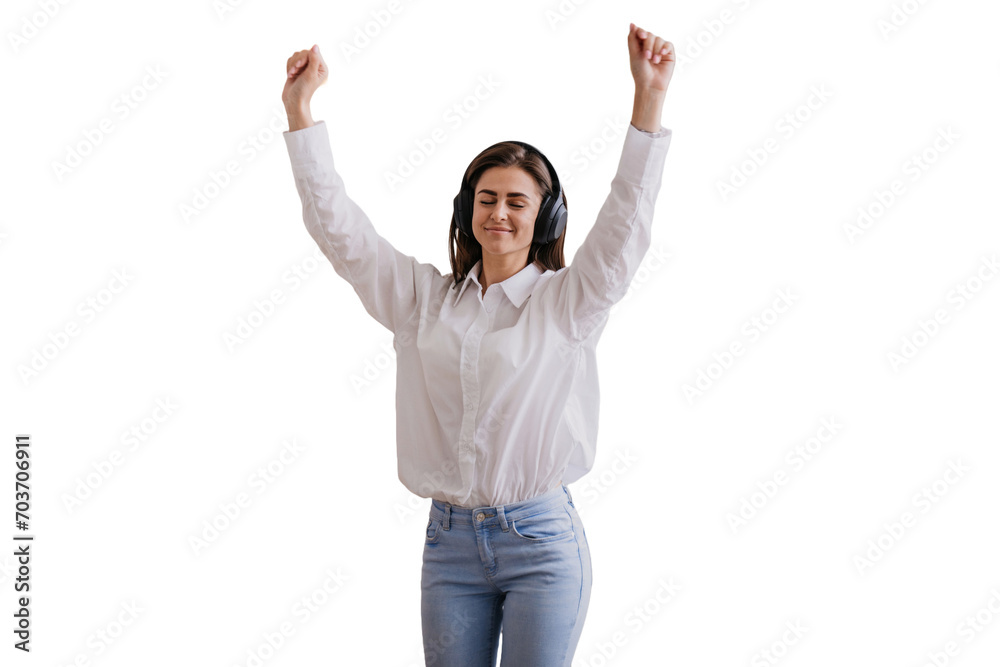 Joyful woman in white celebrating success with arms raised uses headphones eyes closed listening music dancing against transparent background. Joyful woman in white celebrating success with arms raised uses headphones eyes closed listening music dancing against transparent background.