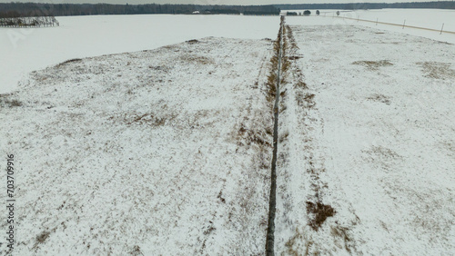 Tableau sur toile Drone photography or rural farmland covered by snow and ice during winter day