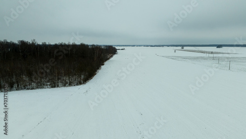 Bilde på lerret Drone photography or rural farmland covered by snow and ice during cloudy winter