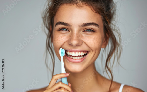 Smiling young woman holding...