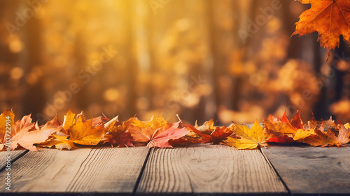 wooden table with beautiful orange leaves autumn background