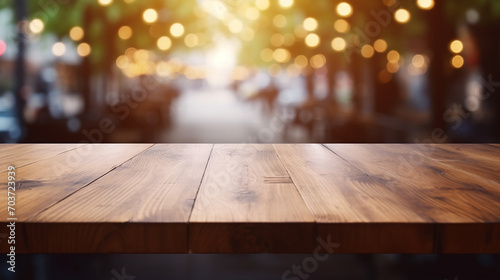 Empty light wood table top with blurred in coffee shop with lights
