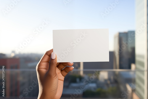 Holding up a empty white business card by female hands