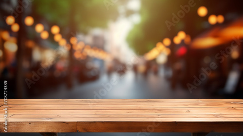 empty wood table in front of blur coffee shop restaurant with blurred light background © Aura