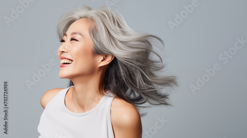Beautiful mature asian woman with glowing healthy skin close-up. Advertising of cosmetics, perfumes, copy space
