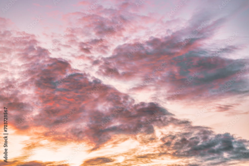 A beautiful sky tinted by the sun leaving vibrant shades of gold, pink, blue and multicolored. Clouds in the twilight evening and morning sky. Cloudy sky background in the evening and during the day.