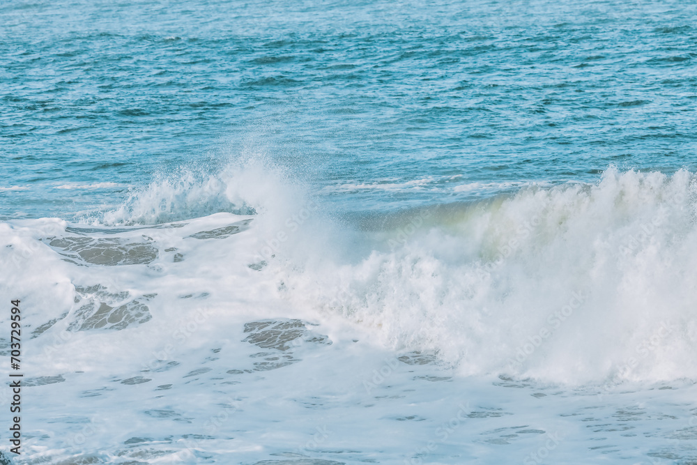 Fototapeta premium Wave splashing close-up. Crystal clear sea water, in the ocean in San Francisco Bay, blue water, pastel colors.