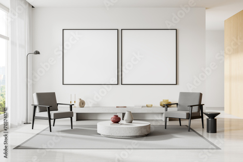 White living room interior with armchairs and posters © ImageFlow
