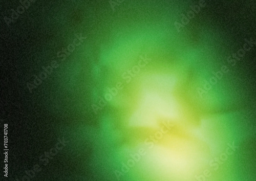 A green flash on a dark background. A bright glow. Noisy background template for decorations, screensavers, posters and interior design