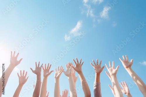 People of different ethnicities raising their hands in the air